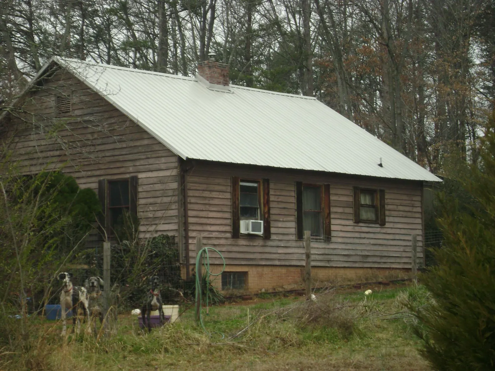 White metal roof on an old wood sided farmhouse, from a Metal Roof Installation job in Jermyn